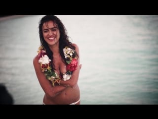 Brunette woman with flower lei sports illustrated swimsuit 2016 uncovered