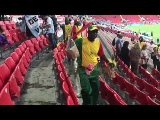 Senegal fans cleaning their section before leaving the stadium