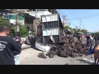 Woman pulled alive from crushed car after being buried under 14 tonnes of soil