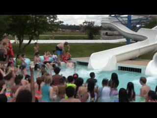 K 5 principal going down the water slide in a suit in tie after the porn surpassed their reading goal this year