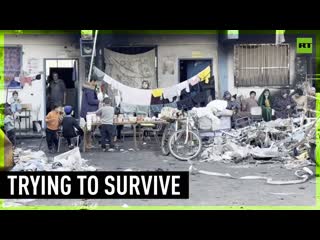 Displaced palestinians seek refuge in debris of beit lahia school