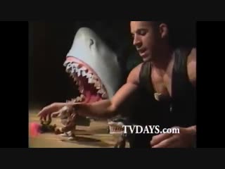 Vin diesel showcasing street shark toys for a toy fair in 1994