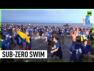 Thousands plunge into freezing waters of magellan strait