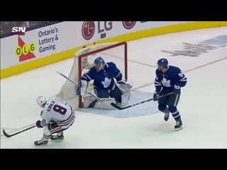 Dominik kubalik bats puck into net after jonathan toews serves up airborne pass