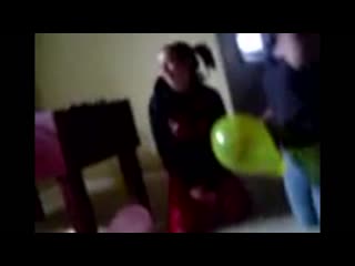 Sitting and squishing balloons at a party