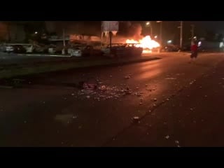 Julio rosas rioters have set fire to the cars in the lot that survived last night s blaze and have torn down street lights