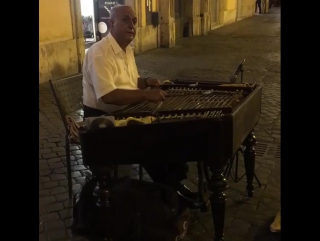 I found this man playing a cimbalom, which is a ty рим