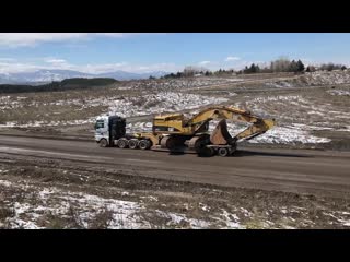 Loading and transporting by side the cat 365c fasoulas heavy transports