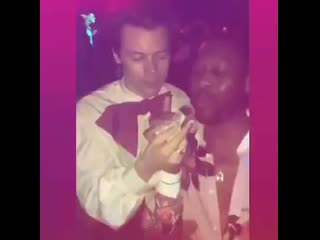 Harry feeding a grilled cheese sandwich to a guy at the gucci vs guccy metgala after party may