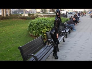 Latex catwoman in catsuit corset and thigh high boots in public