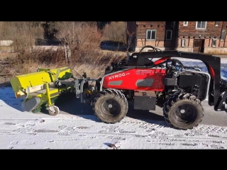 Hymog cleaning a cycle path from snow operator sits in the warm office