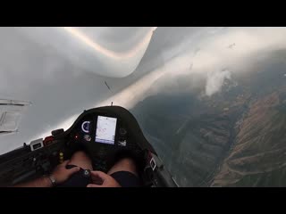 Gliding around big thunder storm over the mountains