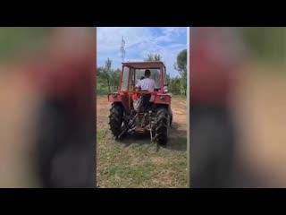 Nemanja matić in his home village vrelo in serbia, driving a tractor with his son