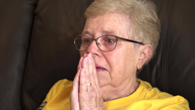 Дедушка и бабушка смотрят как внук выигрывает золотую медаль на олимпиаде