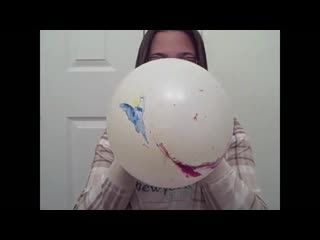 Chick blows up a marbled balloon until it pops