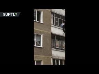 Russian police prevents father from throwing his baby out of the window