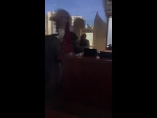 Kataib hizbulla militia and pmf protesters and u s embassy guards are separated by a glass barrier