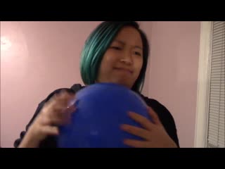 Girl blows up a balloon for her balloon phobic friend and tries to finger pop it but fails