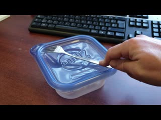 A fork and a plastic lid