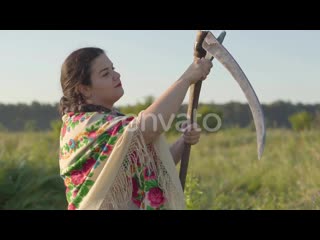 24191805 portrait of beautiful overweight woman sharpening scythe preparing to start mow on the green summer by photo oles previ