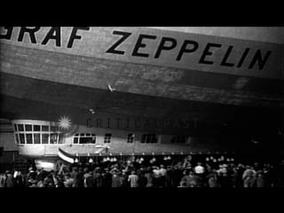 Men repair damaged fin of lz 127 graf zeppelin airship in hangar after arriving stock footage