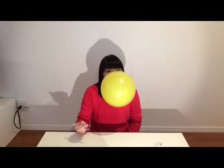 Japanese girl blows and pops balloons in her face with a little help from a bic pen