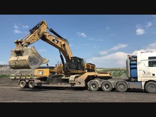 Huge liebher cat and komatsu loading unloading by side fasoulas transports