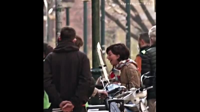 Lady gaga and adam driver laughing on the set of house of gucci as adam’s vespa starts to