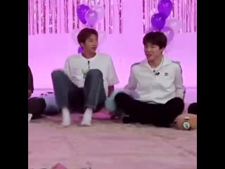 Jimin streching out his leg and joon doing the same