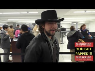 Jackson rathbone talks about what hats are cool to wear while departing at lax airport in los angele