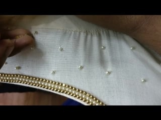 Finishing pearl work on a salwar