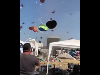 Loos bolted tents going up in a mini tornado