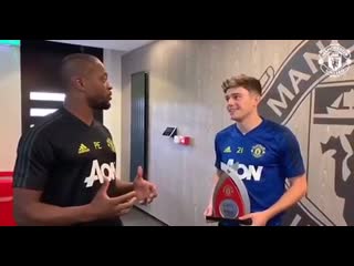 Patrice evra presents daniel james with the player of the month award