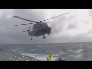 Lynx helicopter landing on ship in rough sea