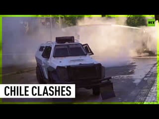 Tear gas & water cannons protesters clash with police in santiago