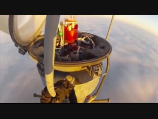 Changing a light bulb on top of a 2000ft mast, while the clouds are below you