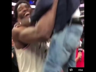 Embiid celebrates with kevin hart then proceeds to pick him up like a little boy