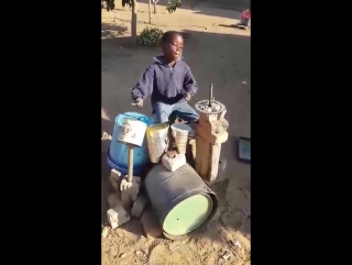 Boy playing on makeshift drums