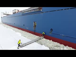 This is how a pilot gets onto a moving container ship in an icy port