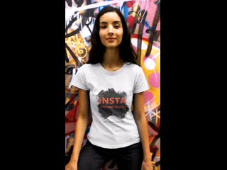 T shirt video of a dark haired woman featuring a grafitti wall 23260 mp4