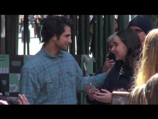 Tyler posey from the film truth or dare signs autographs and poses for photos with fans as he leaves