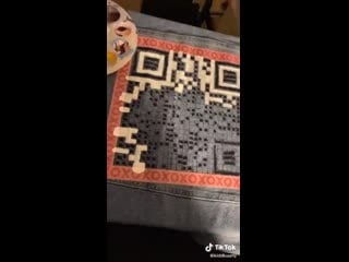 She painted the qr code for on mv on the back of her jacket