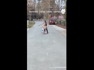 Lyla oshie learning how to ride a bike with help from papa