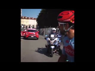 Spectator trying to take water bottle from a pro cyclist