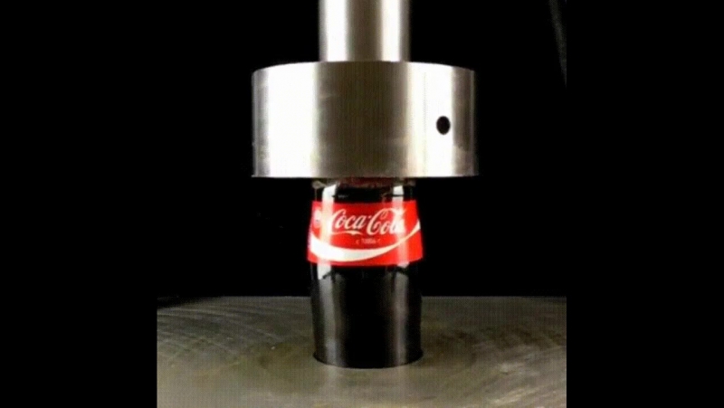 Бутылка колы под гидравлическим прессом