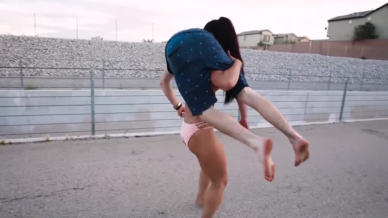 Hot muscle girl flexing and lifting man