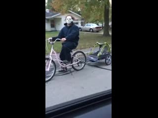 Man gets scolded by his wife for riding the neighborhood on a bike, dressed up as michael myers (halloween)