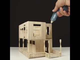 The finished result of a house entirely from popsicle sticks