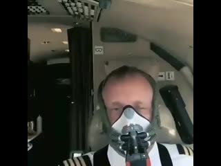 Pilot demonstrating how fast he can put the oxygen mask in case of an emergency