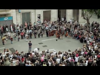 A little girl gives coins to a street musician and gets the best surprise in return